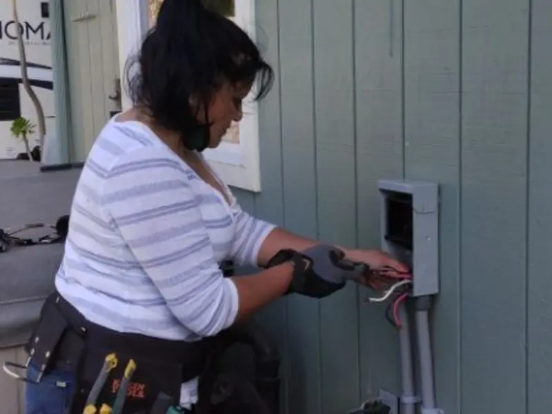 Licensed electrician wiring an exterior subpanel in Rio Linda