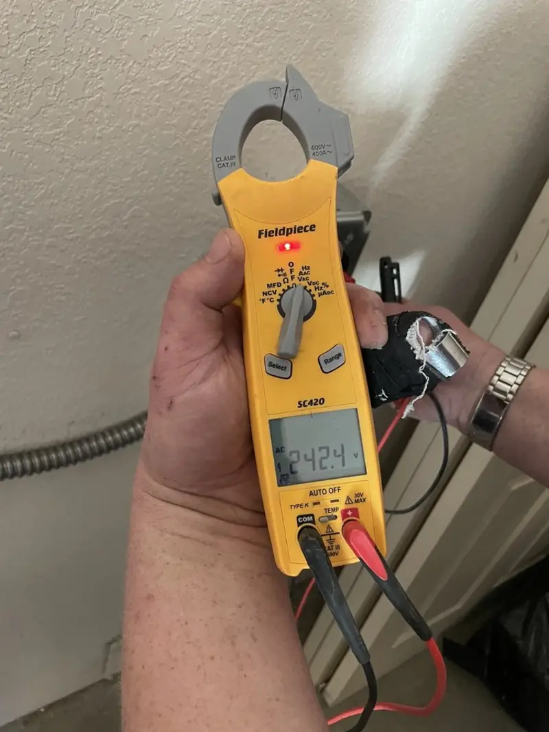 Voltage testing with clamp meter during Recessed Lighting Installation in Rio Linda